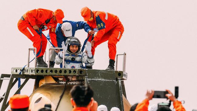 Chinese astronaut Ye Guangfu is assisted by officials to leave the capsule of the Shenzhou-13 spacecraft after landing in China's Inner Mongolia. The return to Earth of three astronautsafter six months at China’s new space station marked a landmark step in the country’s space ambitions, ending its longest crewed mission ever. Picture: AFP