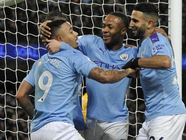 Manchester City's Gabriel Jesus, left, celebrates with Raheem Sterling and Riyad Mahrez, right, after scoring his side's third goal during the English Premier League soccer match between Manchester City and Leicester City at Etihad stadium in Manchester, England, Saturday, Dec. 21, 2019. (AP Photo/Rui Vieira)