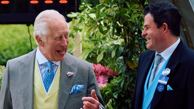 King Charles III (left) speaks with trainer Henry Dwyer after Asfoora’s Royal Ascot victory. Picture: AFP