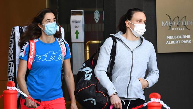 Tennis player Alize Cornet of France (L) and coach Sandra Zaniewska leave hotel quarantine for a practice session in Melbourne. Picture: AFP