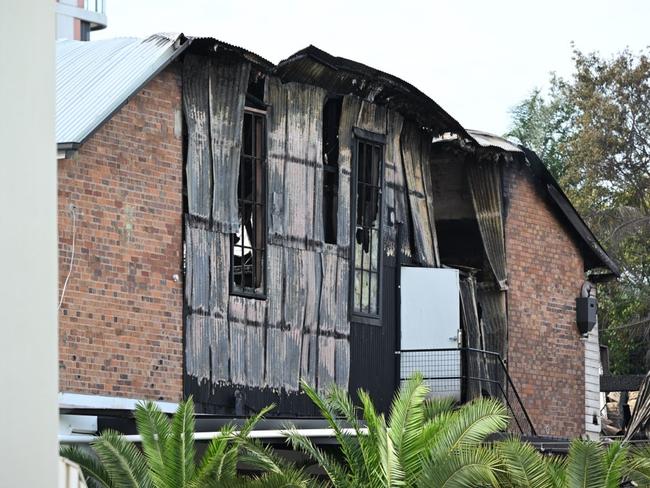 Police and fire investigators picture at the scene of yesterdays fire - A monster fire has destroyed two Brisbane buildings and left the city engulfed in smoke, streets shut down and a person fighting for life. The fire broke out in an abandoned building on Hubert St in Woolloongabba about 4.30pm on Wednesday before quickly spreading to a second building. Picture Lyndon Mechielsen