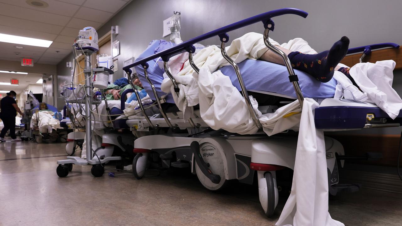 Patients lie on stretchers in a hallway in the overloaded Emergency Room at Providence St. Mary Medical Center amid a surge in COVID-19 patients in Southern California. Picture: Mario Tama/Getty Images/AFP