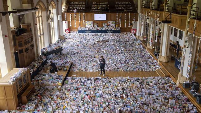 Captain Tom Moore's grandson Benjie stands in the Great Hall of Bedford School, where more than 120,000 birthday cards sent from around the world are being opened and displayed by staff. Picture: PA