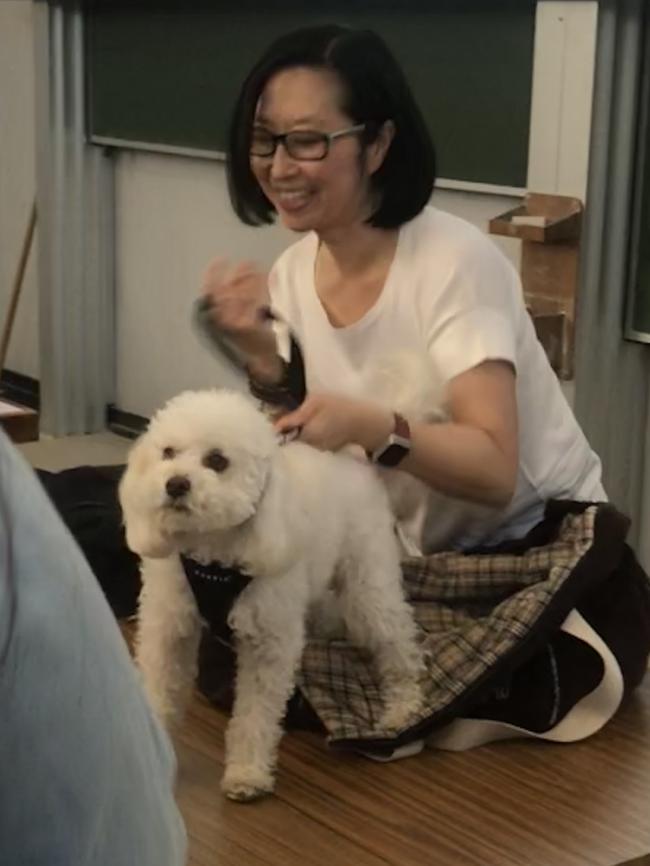 University of Sydney course Introduction to Diversity Lecturer Prof Jane Park with her dog Jae as a student approaches to pat it.