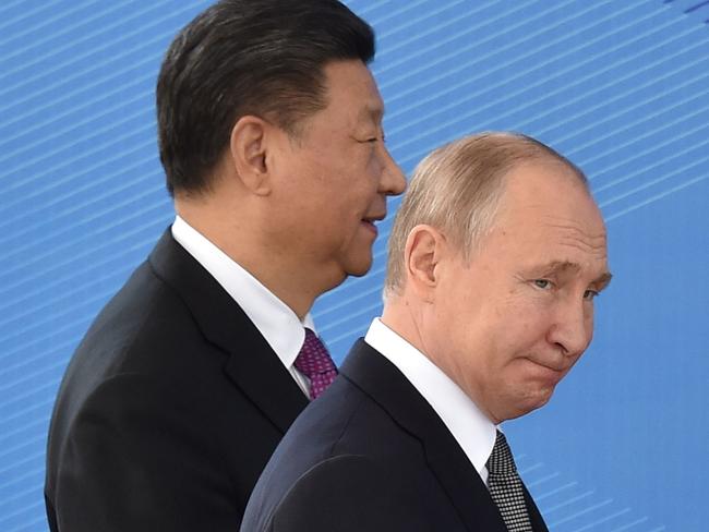 (FILES) In this file photo taken on June 14, 2019, Russia's President Vladimir Putin and China's President Xi Jinping walk as they attend a meeting of the Shanghai Cooperation Organisation (SCO) Council of Heads of State in Bishkek. - Xi Jinping secured a historic third term as China's leader on October 23, 2022 and promoted some of his closest Communist Party allies, cementing his position as the nation's most powerful leader since Mao Zedong. (Photo by Vyacheslav OSELEDKO / AFP)