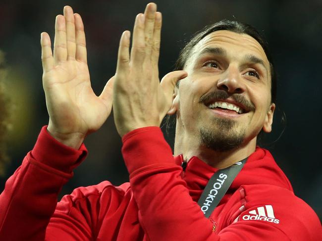 Manchester United's injured Swedish striker Zlatan Ibrahimovic (R) celebrates after his team won the UEFA Europa League final football match Ajax Amsterdam v Manchester United on May 24, 2017 at the Friends Arena in Solna outside Stockholm. / AFP PHOTO / Soren Andersson