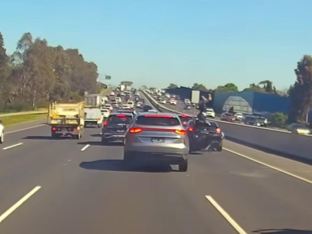 A motorcyclist has found himself on top of a car in a brutal collision caught on a dashcam.