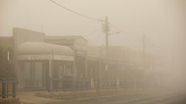 The main street of Bermagui covered in smoke on January 4, 2020. The town has again seen thousands of tourists evacuated due to the closure of the Victorian border. Picture: Sean Davey