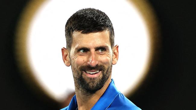 TOPSHOT - Serbia's Novak Djokovic reacts to a point against Spain's Carlos Alcaraz during their men's singles quarterfinal match on day ten of the Australian Open tennis tournament in Melbourne on January 22, 2025. (Photo by Martin KEEP / AFP) / -- IMAGE RESTRICTED TO EDITORIAL USE - STRICTLY NO COMMERCIAL USE --