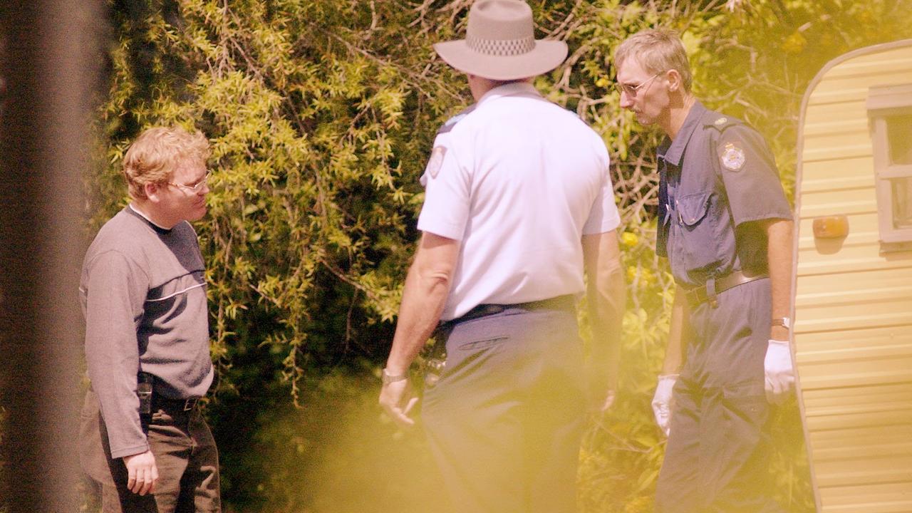 Police search the area where Tamara June Smith, 24 years, was found. She was murdered in Isabel Street, in central Toowoomba, Easter Sunday, March 31, 2002. Photo Kevin Farmer