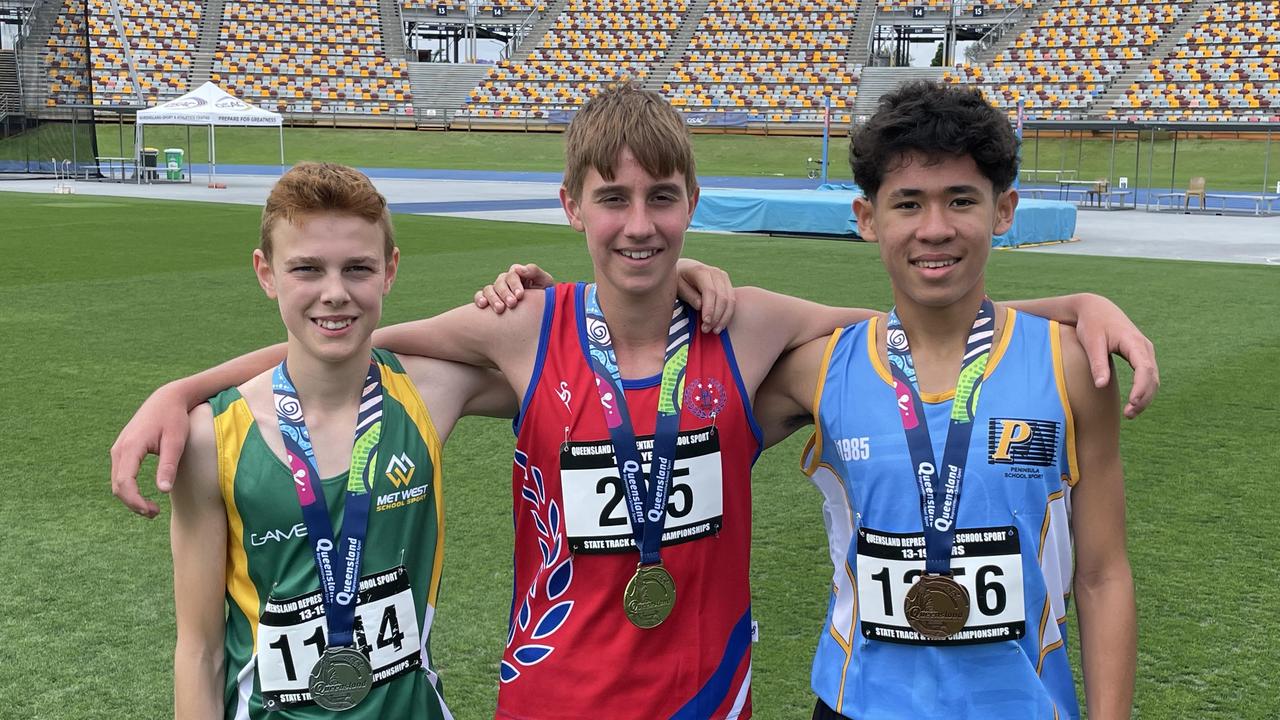 Harristown SHS's Cedar Johnson, middle, won the 1500m 14 years. On either side of him is Xavier Morrell and Issac Blue.