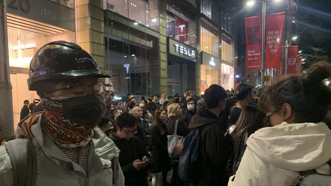 Hundreds of people wearing masks protest to show solidarity with the protesters in Hong Kong. Picture: Campbell Gellie