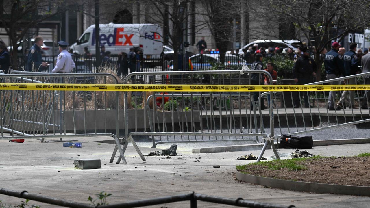 Police crime tape is strung at the site across from Manhattan Criminal Court in New York City after a man reportedly set himself on fire. (Photo by ANGELA WEISS / AFP)