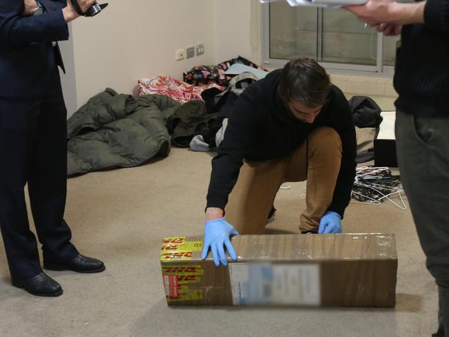 Officers search the consignment. Picture: NSW Police