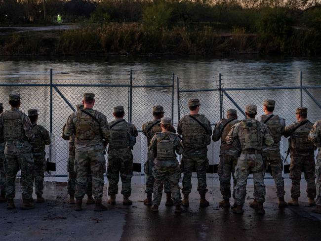 Texas National Guard soldiers stand guard on the banks of the Rio Grande in Eagle Pass. Picture: Brandon Bell (Getty Images via AFP)