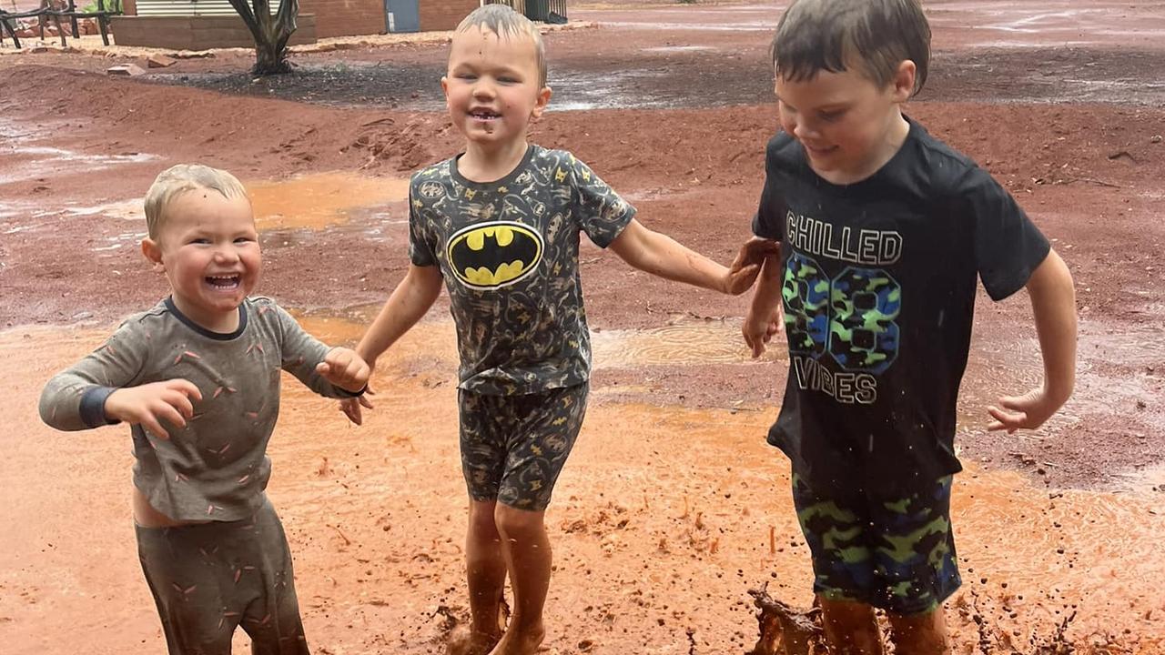 Mason, Hamish and Jack enjoying the rain at Mt Ive Station, Gawler Ranges on Sunday, December 10, 2023. The station has had about 70mls of rain since Friday. Picture: Mt Ive Station