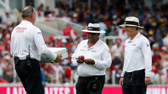 A new box of balls is brought out to umpires, Ahsan Raza (C) and Chris Gaffaney (R). Picture: AFP