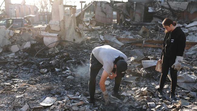 Congregants search through the remains of Pasadena Jewish Temple &amp; Center, which served Pasadena for over 100 years and was destroyed in the Eaton Fire. Picture: Getty Images via AFP