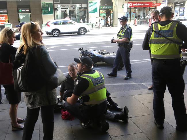 Police on the scene of an accident between a motorcycle and a taxi outside Flinders Street Station on Thursday, January 19, 2017, in Melbourne, Victoria, Australia. Picture: Hamish Blair