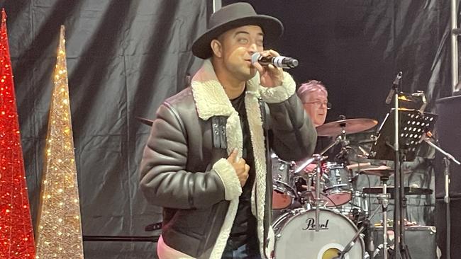 Headliner Chris Sebastian belts out some tunes at Manningham's 2022 Carols at Ruffey Lake Park in Doncaster.