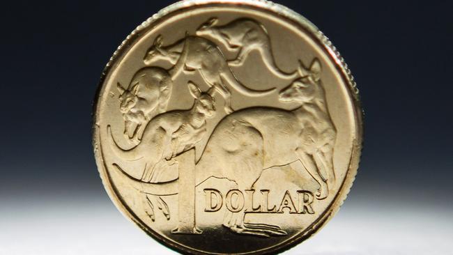 An Australian one-dollar coin is arranged for a photograph in Sydney, Australia, on Wednesday, April 17, 2013. Direct trading between the Australian dollar and yuan started on April 10. Photographer: Ian Waldie/Bloomberg