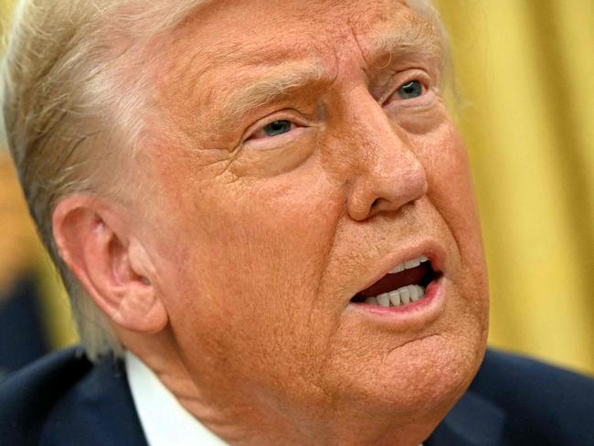 TOPSHOT - US President Donald Trump speaks to the press after signing an executive order in the Oval Office of the White House in Washington, DC on January 31, 2025. (Photo by Mandel NGAN / AFP)