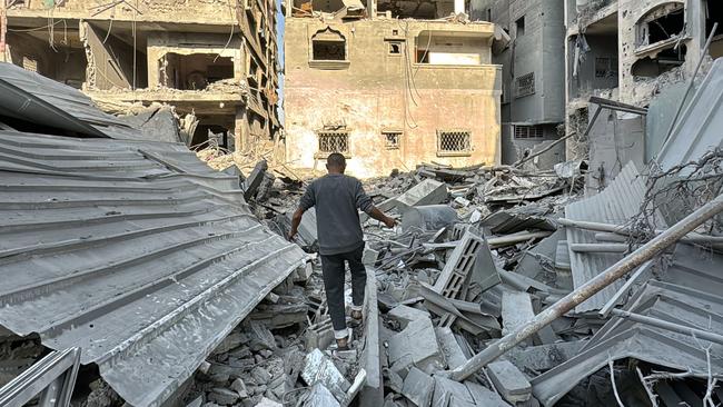 A Palestinian inspects the rubble of a building in Beit Lahia, in the northern Gaza Strip, as the war between Israel and Hamas militants continues. Picture: AFP