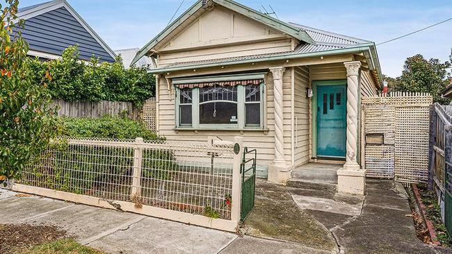 The house has a kitchen and meals area overlooking a rear yard, plus a separate laundry