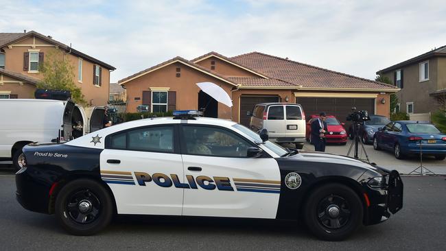 Police outside the torture house which inside was a stinking hellhole. Picture: Frederic J Brown