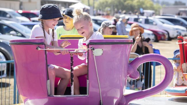 Emily Redman 6 and Mya Williams 3 of Huonville ride the Tea Cups at A Taste of the Huon. Picture: Chris Kidd