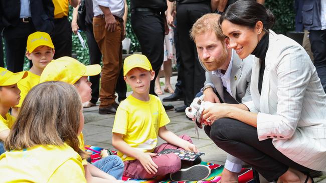 Harry and Meghan talk with young kids during day two of the Invictus Games in Sydney. Picture: Getty