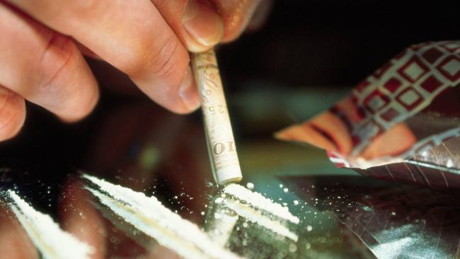 Undated. Generic pic of a person rolling a $50 note to snort lines of cocaine off a mirror on a dinner plate. Drug use.