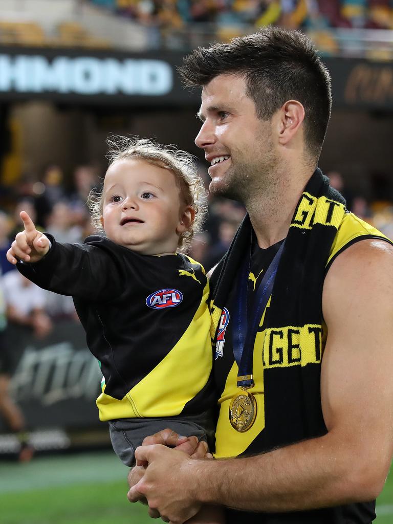 Cotchin celebrates the 2020 grand final with his youngest daughter. Picture: Getty