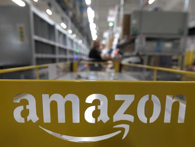 (FILES) In this file photo taken on December 17, 2019 This picture shows the logo of US online retail giant Amazon at the distribution center in Moenchengladbach, western Germany, on December 17, 2019. - Amazon CEO Andy Jassy said March 20, 2023 he was cutting 9,000 more jobs from the online retail giant's workforce, following the 18,000 that were axed in January. (Photo by INA FASSBENDER / AFP)