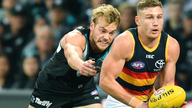 Jack Watts of the Power attempts to tackle Rory Laird on Saturday. Picture: AAP Image/David Mariuz