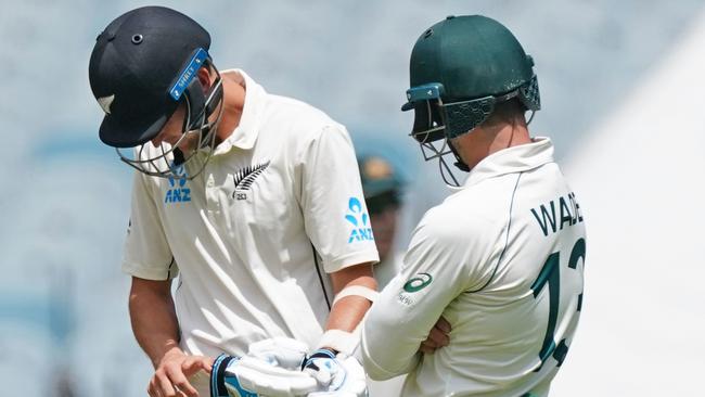 Trent Boult inspects his hand after he was struck by a delivery at the MCG on Saturday.