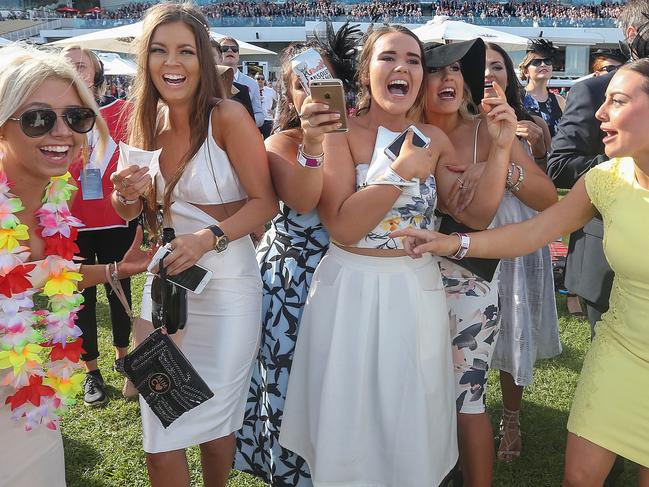 Melbourne Cup Carnival.Oaks Day.The sun shines again as these punters cheer home their winner in the Crown Oaks.Picture:Ian Currie