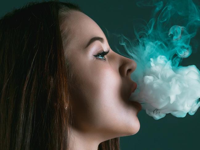 The face of vaping young woman on black studio backgroundIStock imageCredit:master1305 Stock photo ID:687438202Upload date:May 24, 2017