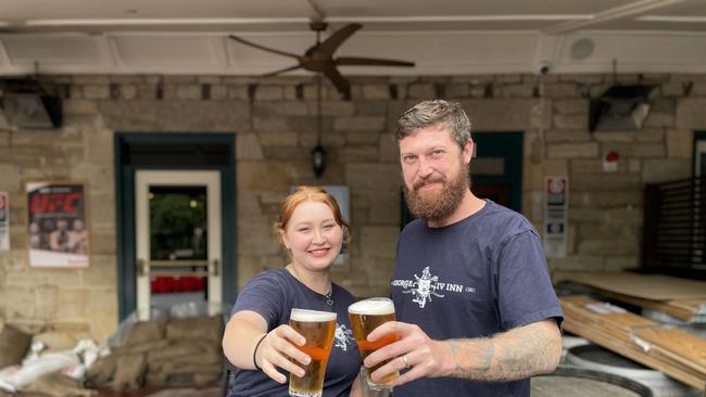 Emily Jones and Luke Simpson are pouring beers at The George IV Inn after it reopened when Stonequarry Creek receded. Picture: Annie Lewis Photo taken on March 3, 2022.