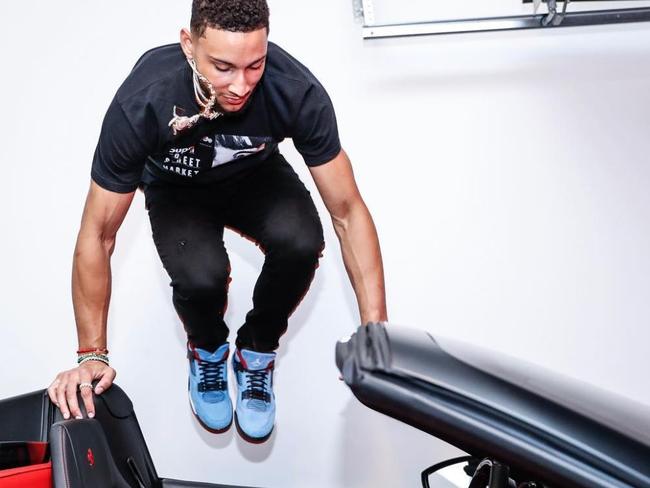 A picture from Ben Simmons’ Instagram page showing him jumping into his Ferrari.