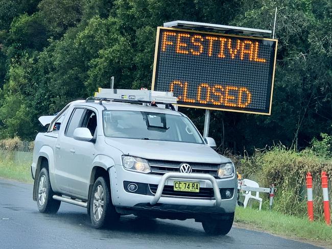 BYRON BAY , AUSTRALIA - NewsWire Photos April 01, 2021: A Festival contractor drives past a Large electronic ÃFESTIVAL CLOSEDÃ sign which now stands at the very front of the Byron Bay Blues Festival precinct after it was announced late yesterday that the event would not be going ahed due to a current Covid-19 outbreak locally.Picture: NCA NewsWire / Scott Powick