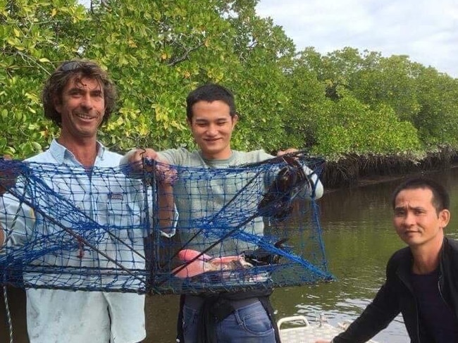 A local Daintree crab fisherman, named only as Barry, reportedly with two of the Vietnamese boat people in his dinghy.