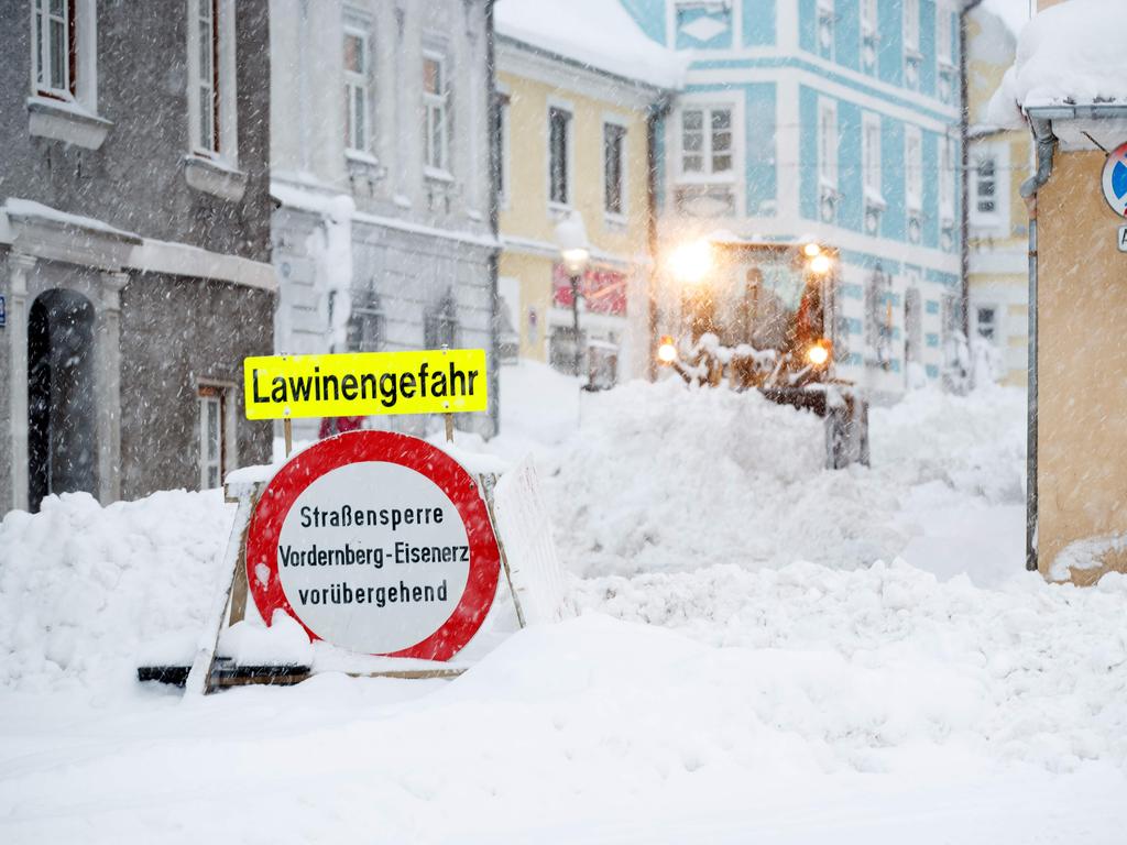 A street sign reading ‘danger of avalanches’ on a snow-covered street in Vordernberg, Austria. Picture: Erwin Scheriau/AFP