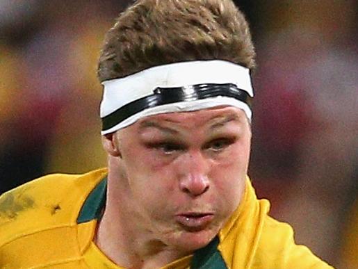 BRISBANE, AUSTRALIA - JUNE 22: Michael Hooper of the Wallabies is tackled during the First Test match between the Australian Wallabies and the British & Irish Lions at Suncorp Stadium on June 22, 2013 in Brisbane, Australia. (Photo by Cameron Spencer/Getty Images)
