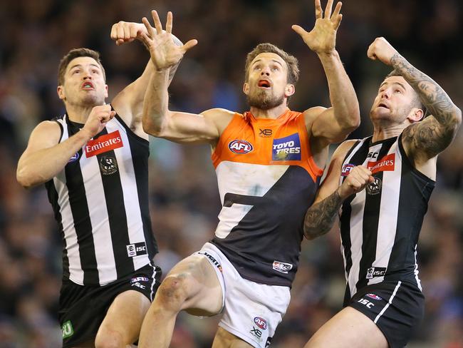 Jack Crisp (left) and Jeremy Howe spoil Giant Brett Deledio. Pic: Michael Klein