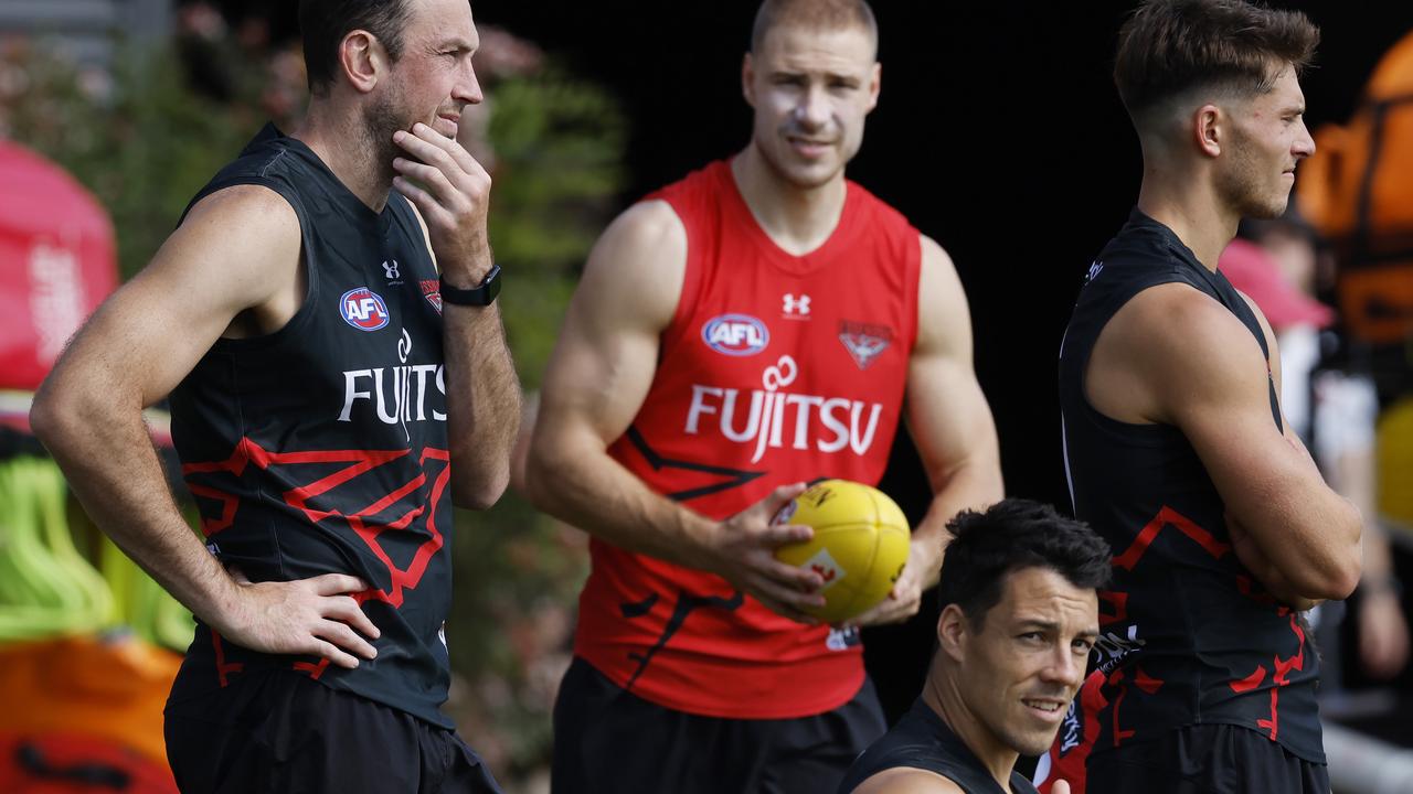 Shiel (bottom right) stretches with new recruits Todd Goldstein (left) and Ben McKay at Essendon training last Thursday. Picture: Michael Klein