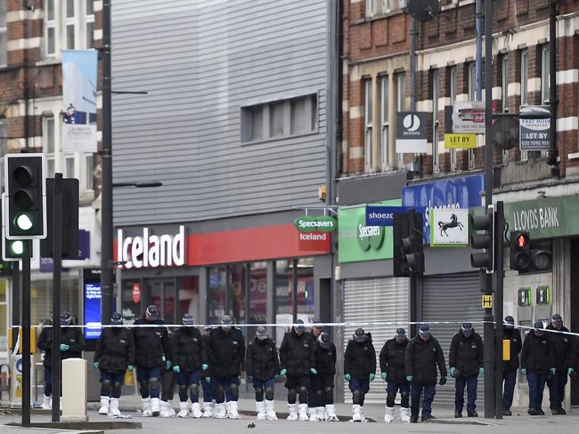 Police officers work at the scene of Sunday's terror stabbing attack. Picture: AP