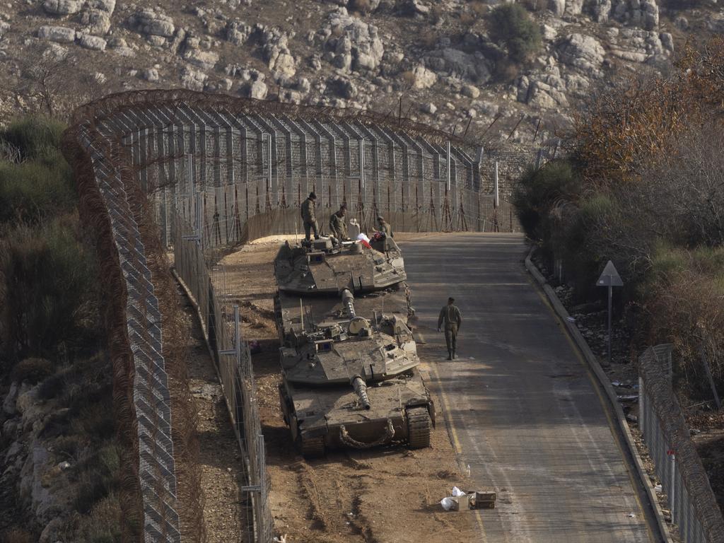 Israeli soldiers stand near tanks near the border with Syria on December 9, 2024. Picture: Amir Levy/Getty Images