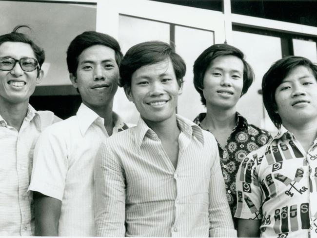 L to R lam Binh, father, now dead: gip Chong Bao, brother, now dead: Nguyen Van Chen, in Darwin, barra fisherman: Lam Tac Tam, Lee Dynasty: Ngo Son Binh, now in Sydney. The day after the group arrived in Darwin in April, 1976, standing outside the Immigration Dept in Darwin. Picture: SUPPLIED