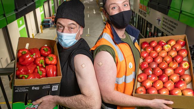 Freshly jabbed Tony Dariol and Kim Driver at the Melbourne Market COVID-19 vaccination hub. Picture: Jason Edwards